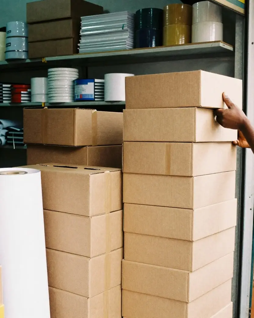 Cartons and reams of paper on shelves in a wholesale supplies shop
