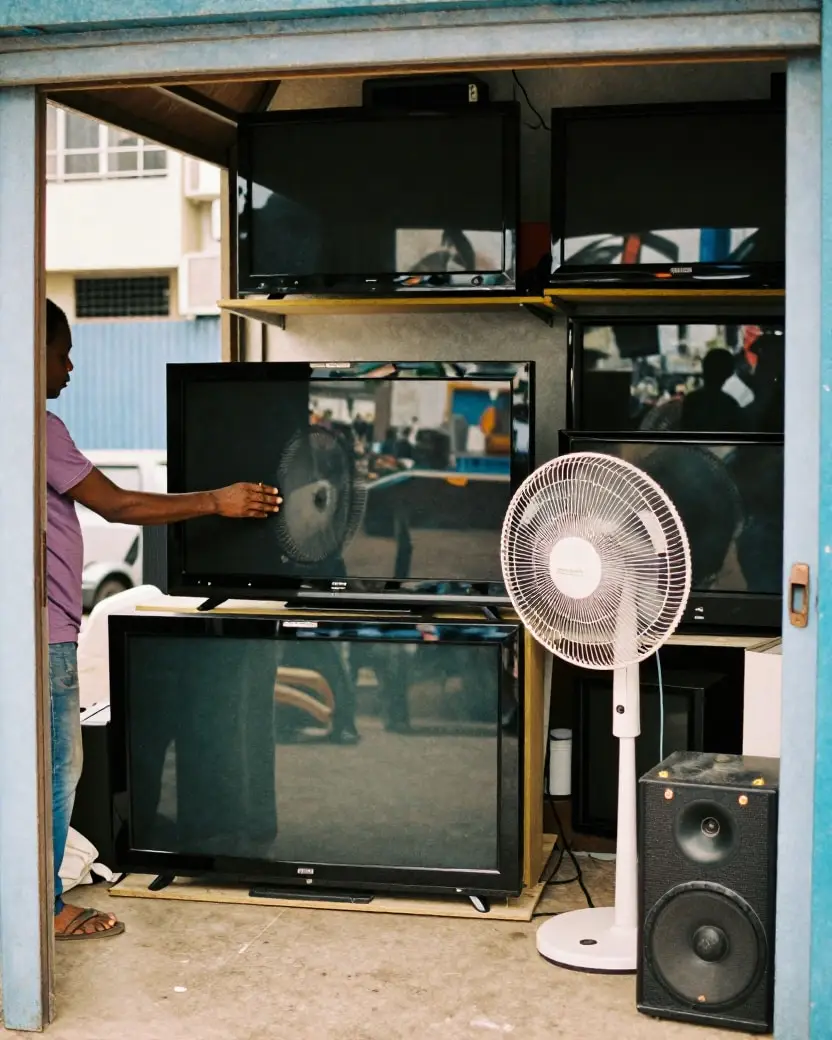 Televisions on shelves in an electronics shop